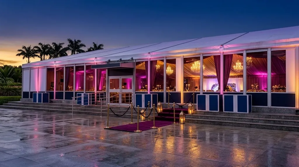The marquee lit in plum and gold for an evening gala